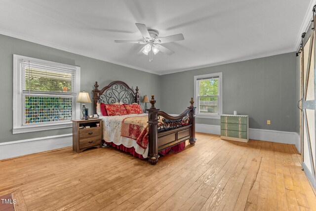 119 Johnson St, Broadway, NC 27505 - bedroom with baseboards, crown molding, a barn door, light wood-style floors, and ceiling fan