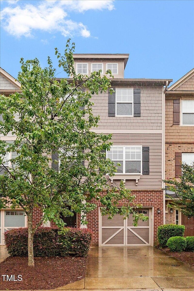 615 Carlton Commons Ln, Cary, NC 27519 - view of front facade with concrete driveway, a garage, and brick siding