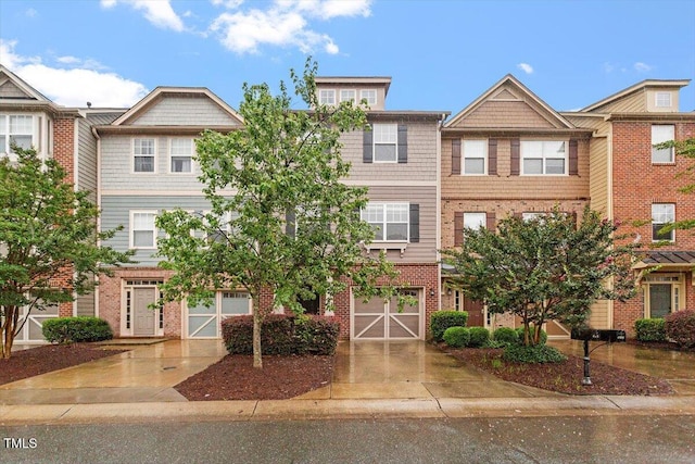 615 Carlton Commons Ln, Cary, NC 27519 - multi unit property with brick siding, concrete driveway, and a garage