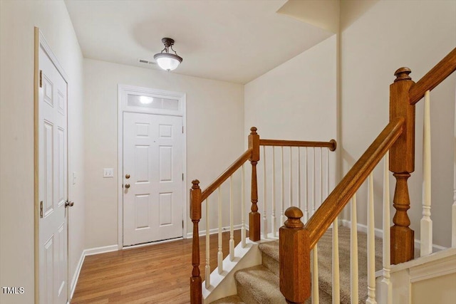 615 Carlton Commons Ln, Cary, NC 27519 - foyer entrance with light wood-style floors, stairway, and baseboards