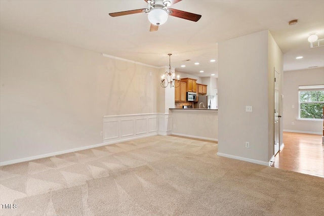 615 Carlton Commons Ln, Cary, NC 27519 - unfurnished living room with light colored carpet, a chandelier, ceiling fan, and recessed lighting