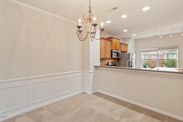615 Carlton Commons Ln, Cary, NC 27519 - kitchen featuring appliances with stainless steel finishes, a chandelier, light carpet, recessed lighting, and brown cabinets