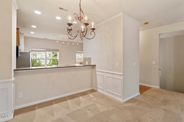 615 Carlton Commons Ln, Cary, NC 27519 - unfurnished dining area featuring a chandelier, light colored carpet, recessed lighting, and a wainscoted wall