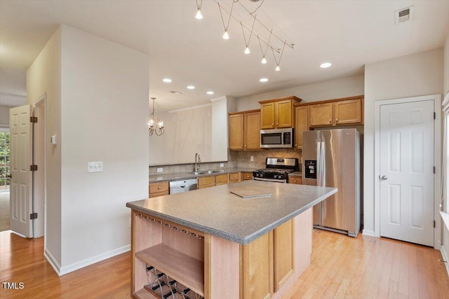 615 Carlton Commons Ln, Cary, NC 27519 - kitchen with appliances with stainless steel finishes, open shelves, a sink, baseboards, and tasteful backsplash