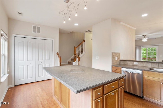 615 Carlton Commons Ln, Cary, NC 27519 - kitchen with dishwasher, light wood-type flooring, a sink, a kitchen island, and recessed lighting