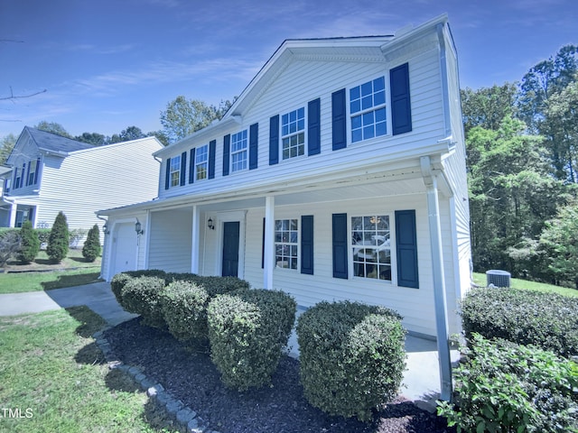 5828 Brambleton Ave, Raleigh, NC 27610 - view of front facade with a garage, central AC unit, and covered porch