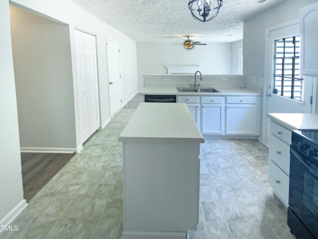 5828 Brambleton Ave, Raleigh, NC 27610 - kitchen featuring a center island, a sink, light countertops, ceiling fan, and black appliances