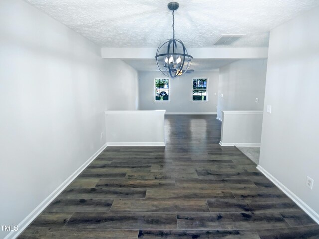 5828 Brambleton Ave, Raleigh, NC 27610 - unfurnished dining area with dark wood-style floors, a chandelier, a textured ceiling, and visible vents