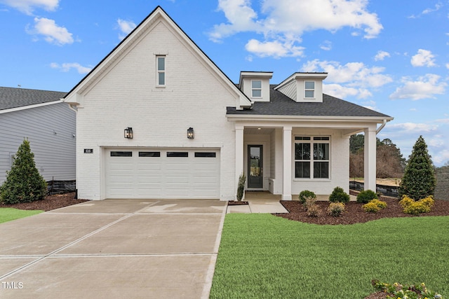 616 Gainer Dr # 15, Raleigh, NC 27610 - view of front facade featuring a garage, driveway, a front lawn, and brick siding