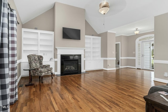 1454 Spring Pond Rd, Nashville, NC 27856 - living room with a fireplace with flush hearth, vaulted ceiling, wood finished floors, baseboards, and built in shelves
