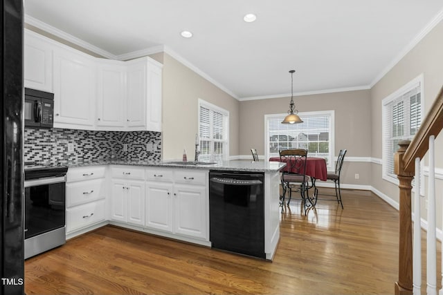 1454 Spring Pond Rd, Nashville, NC 27856 - kitchen featuring dark wood-type flooring, a sink, black appliances, and a peninsula