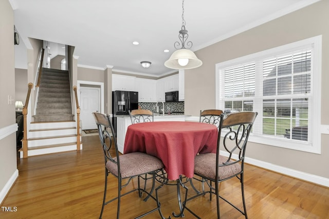 1454 Spring Pond Rd, Nashville, NC 27856 - dining room with light wood-type flooring, baseboards, and ornamental molding
