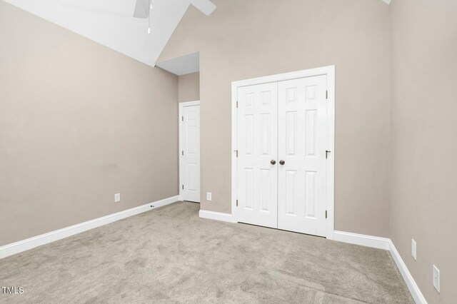 1454 Spring Pond Rd, Nashville, NC 27856 - unfurnished bedroom featuring a closet, baseboards, vaulted ceiling, carpet floors, and ceiling fan