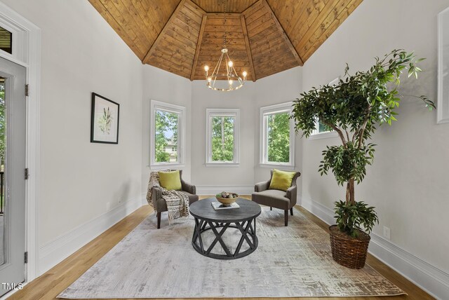 sitting room featuring wood ceiling, a chandelier, high vaulted ceiling, wood finished floors, and baseboards