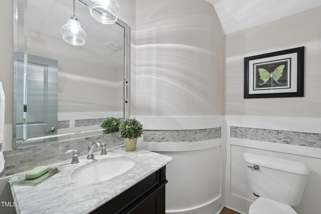 bathroom featuring toilet and vanity