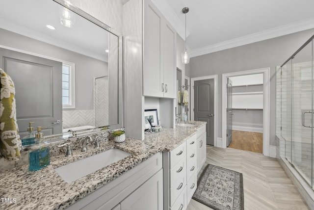 full bathroom featuring a shower stall, a walk in closet, ornamental molding, double vanity, and a tub