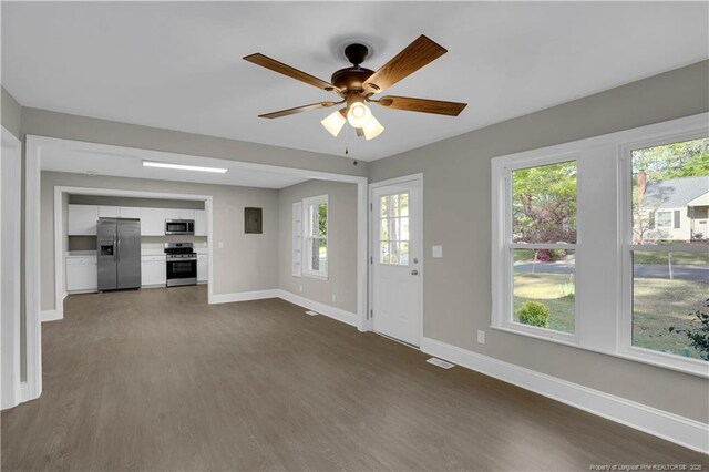 213 Judd St, Fayetteville, NC 28305 - unfurnished living room featuring dark wood finished floors, baseboards, ceiling fan, and plenty of natural light
