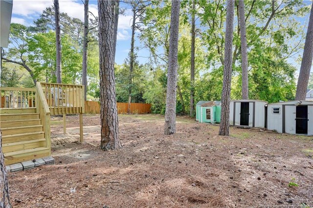213 Judd St, Fayetteville, NC 28305 - view of yard featuring fence, an outdoor structure, and a shed