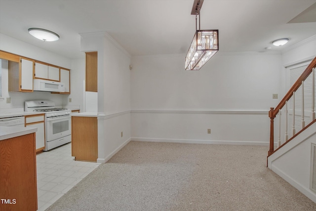 kitchen with white appliances, light countertops, crown molding, baseboards, and a peninsula