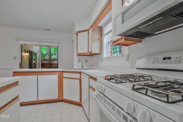 kitchen with white appliances, a sink, light countertops, ornamental molding, and light flooring