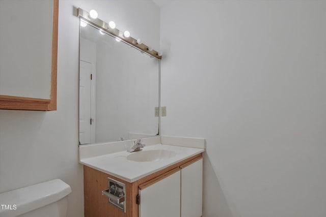 half bathroom featuring toilet and vanity