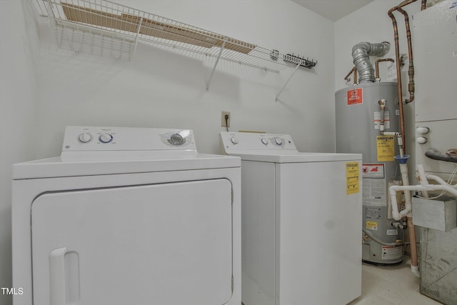 laundry area with washer and dryer and water heater
