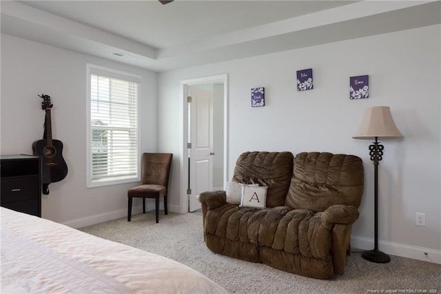 bedroom with light colored carpet and baseboards