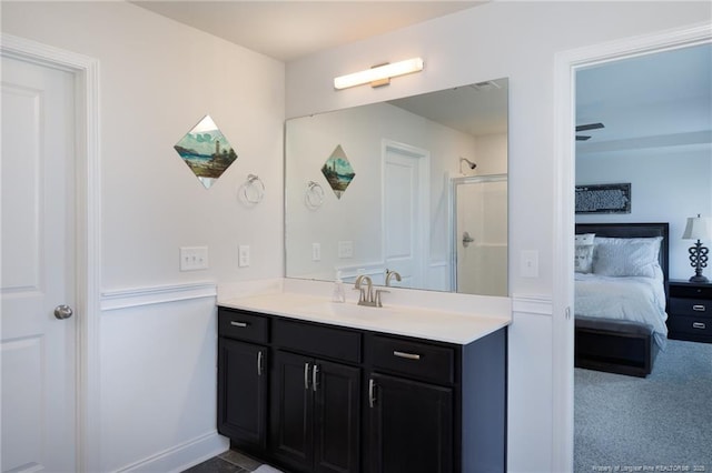 full bath featuring a shower stall, vanity, and ensuite bathroom