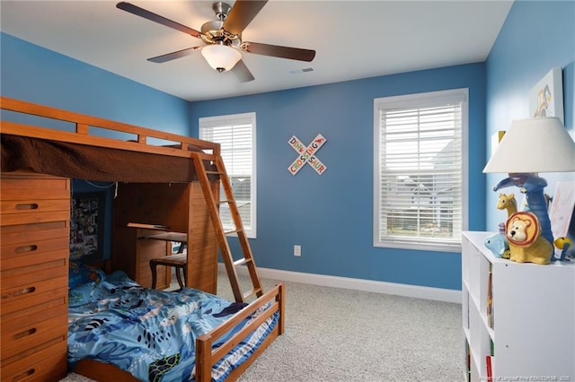 carpeted bedroom featuring baseboards and ceiling fan