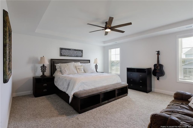 429 Letterfearn Dr, Fayetteville, NC 28311 - carpeted bedroom featuring a tray ceiling, baseboards, and a ceiling fan
