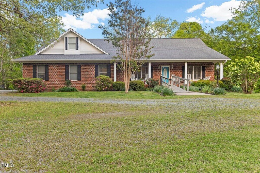 2456 Nealwood Ave, Graham, NC 27253 - view of front facade featuring brick siding, a front yard, and a porch