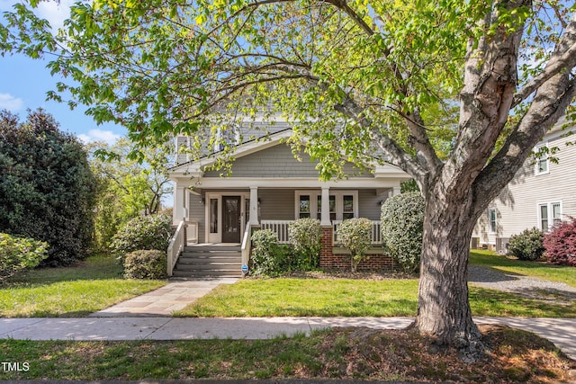 104 E Wilson St, Mebane, NC 27302 - view of front facade with covered porch and a front lawn