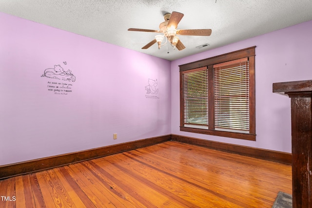 104 E Wilson St, Mebane, NC 27302 - empty room featuring baseboards, ceiling fan, wood finished floors, and a textured ceiling