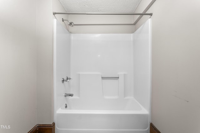 104 E Wilson St, Mebane, NC 27302 - bathroom with a textured ceiling and tub / shower combination