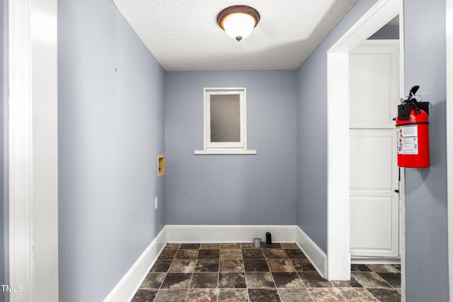 104 E Wilson St, Mebane, NC 27302 - washroom featuring a textured ceiling, baseboards, dark stone finish floors, and washer hookup