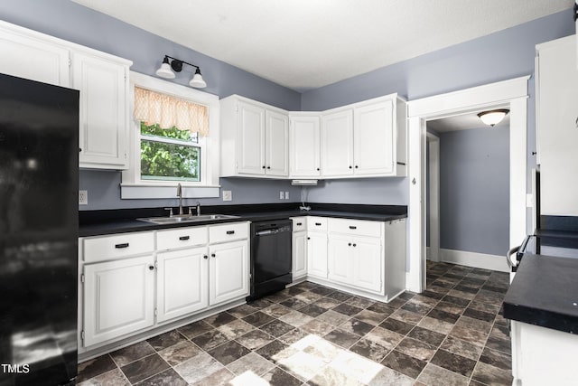 104 E Wilson St, Mebane, NC 27302 - kitchen with black appliances, dark countertops, a sink, and white cabinets