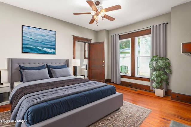 104 E Wilson St, Mebane, NC 27302 - bedroom with light wood-style flooring, a ceiling fan, and baseboards