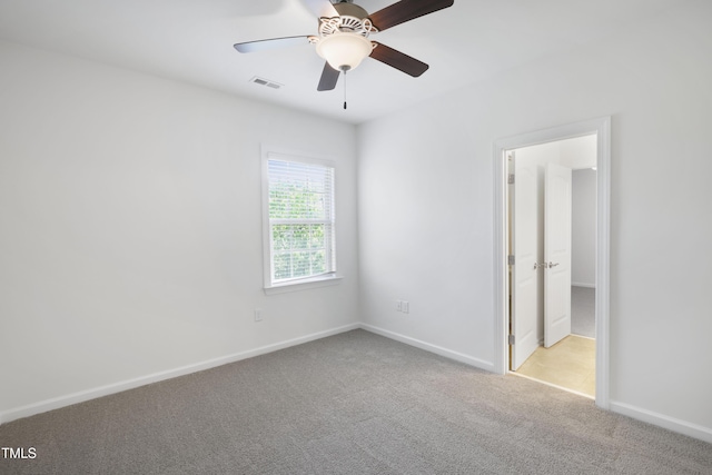 unfurnished bedroom with visible vents, carpet flooring, baseboards, and a ceiling fan