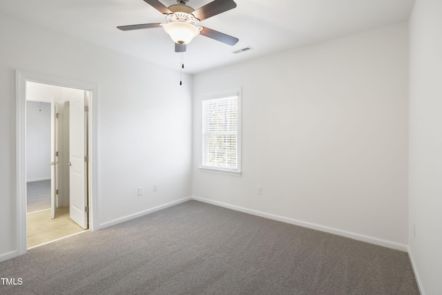 unfurnished bedroom with carpet, visible vents, baseboards, and ceiling fan