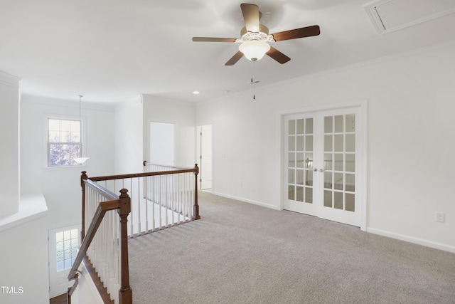 interior space with attic access, french doors, baseboards, a ceiling fan, and ornamental molding