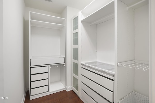 spacious closet featuring dark wood finished floors and visible vents