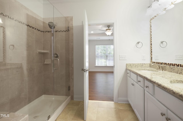 full bathroom with tile patterned flooring, a sink, baseboards, a stall shower, and ceiling fan