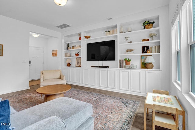 1501 Addison Lake St, Fuquay Varina, NC 27526 - living room featuring built in features, wood finished floors, and visible vents