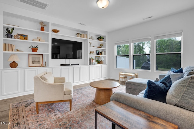 1501 Addison Lake St, Fuquay Varina, NC 27526 - living room with wood finished floors, visible vents, and built in shelves