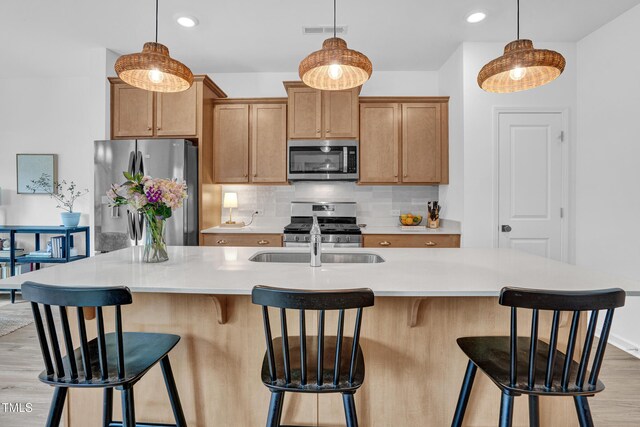 1501 Addison Lake St, Fuquay Varina, NC 27526 - kitchen with decorative backsplash, light wood-type flooring, stainless steel appliances, decorative light fixtures, and visible vents
