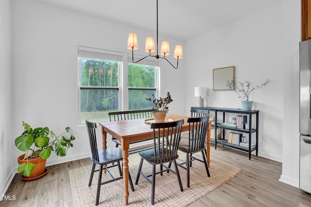 1501 Addison Lake St, Fuquay Varina, NC 27526 - dining room with light wood-style floors, baseboards, and an inviting chandelier
