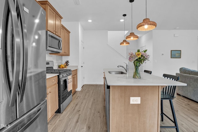 1501 Addison Lake St, Fuquay Varina, NC 27526 - kitchen with light wood-type flooring, stainless steel appliances, a sink, and a breakfast bar area