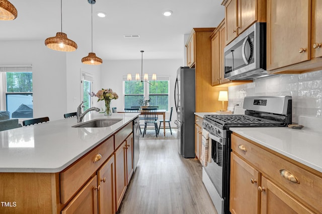 1501 Addison Lake St, Fuquay Varina, NC 27526 - kitchen featuring stainless steel appliances, light countertops, visible vents, a sink, and light wood-style flooring