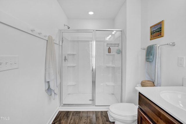 1501 Addison Lake St, Fuquay Varina, NC 27526 - bathroom with wood finished floors, toilet, vanity, baseboards, and a stall shower