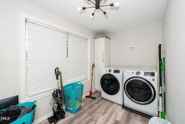 clothes washing area with cabinet space, separate washer and dryer, light wood finished floors, and baseboards